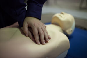 CPR practise dummy being used | Featured image for Electrical Training Courses | Electrical RTO & Training for Electricians by Get Skilled Training.