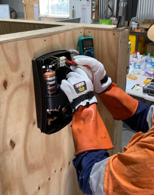 Man working on electrical outlet | Featured image for Restricted Electrical Licence Course Queensland by Get Skilled Training.