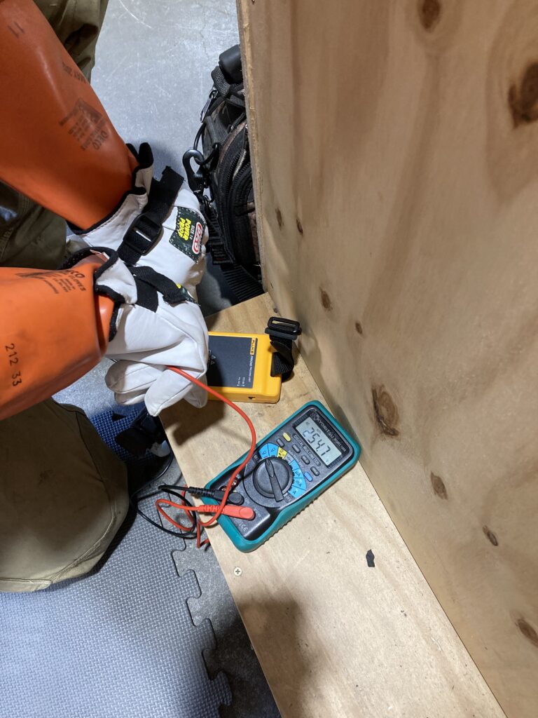 Man conducting electrical tests.