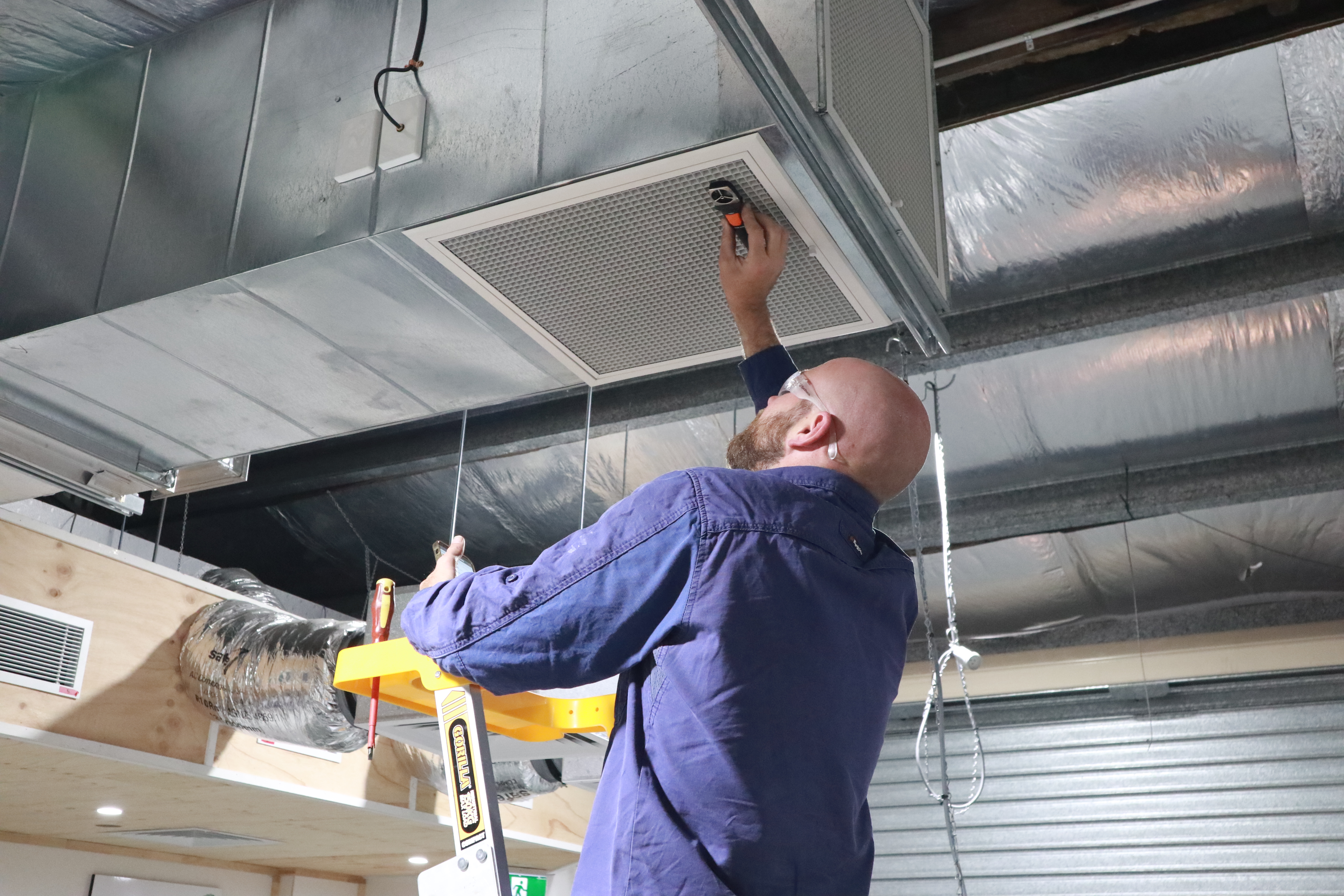 Man working on air vent.