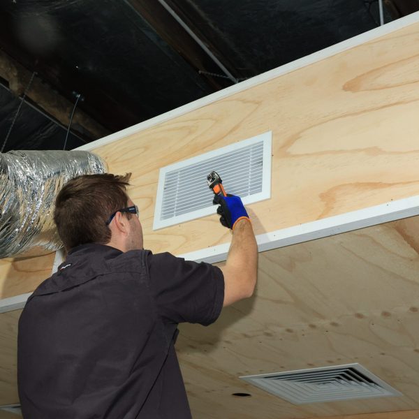 Man measuring airflow from air conditioning vent | Featured image for Student and teacher measuring current on air conditioning unit | Featured image for Refrigeration vent with solenoid unit circled | Featured image for Certificate III in Refrigeration and Air Conditioning by Get Skilled Training