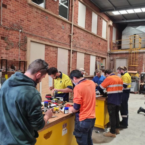 Group of students in the workshop doing an electrical course