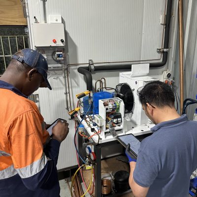 Two men doing electrical work as part of the Cert lll training course