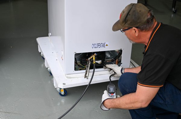 Man checking for gas leaks around fitting | Featured image for Gas Work License Hydrocarbon page on Get Skilled Training.