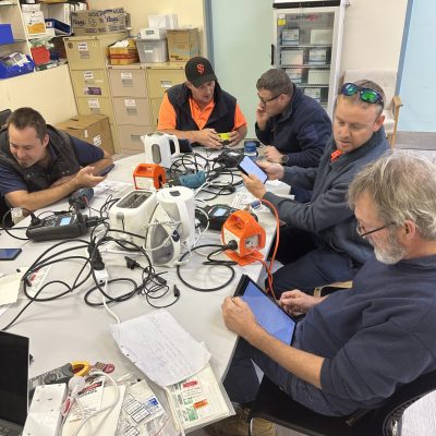 A man looking at an iPad learning how to do a task as part of the test and tag course