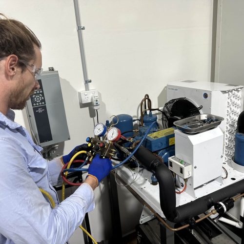 Man working on electrical equipment as part of refrigeration course