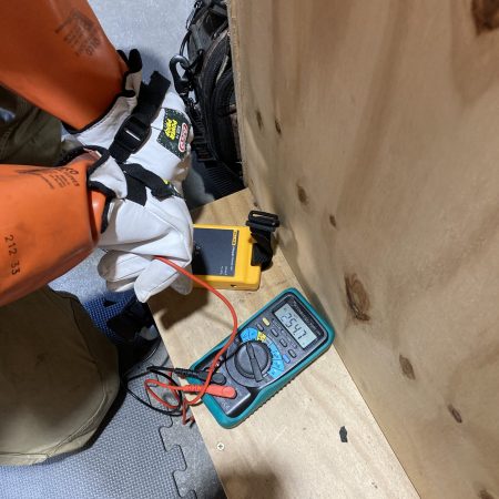 Man conducting electrical tests.