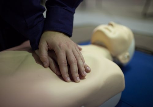 CPR practise dummy being used | Featured image for Electrical Training Courses | Electrical RTO & Training for Electricians by Get Skilled Training.